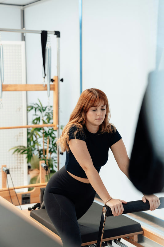 Woman Practicing Pilates At Home